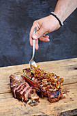 Grilled porterhouse steak with onions