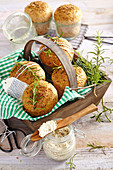 Easter buns made from spelt yeast dough with rosemary served with a cream cheese, tomato and herb dip