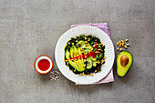 Green salad with kale, avocado, cucumber, pine nuts and honey dressing