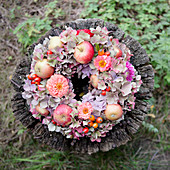 Late-summer wreath of hydrangeas, zinnias and apples