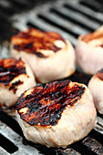 Grilled veal steaks on a grill (close up)