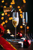 Glasses of champagne with candles and Chrsitmas decoration