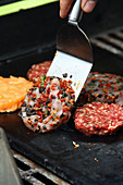 Various burger patties on a grill