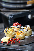 Grilled puff pastry roses with pineapple, kiwi, banana and berries