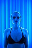 Woman in tanning booth