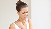 Woman rubbing painful shoulder