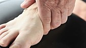 Man rubbing foot