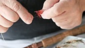 Man preparing fishing line with shaking hands