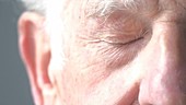 Elderly man opening eye