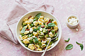 Pasta shells with broad bean, bacon, curd cheese and mint