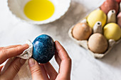 Polishing egg with oil, egg dyed with red cabbage