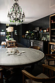 Round dining table and chairs in black kitchen