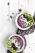 Blackberry smoothie bowls topped with kiwi, coconut, and chia seeds