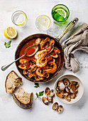 Cooked Vongole Clams and pink Prawn Shrimp with tomato sauce and parsley in cooking pan