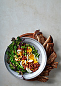 Egg salad with sun-dried tomato-and-cashew nut pesto and broccolini