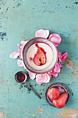 Semolina pudding with poached raspberries, roses and pears