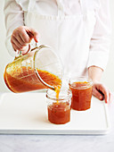 Pouring jam into a jar