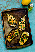 Baked eggplant with olive oil and parsley on a baking sheet