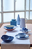 Ceramic bowls, plates, jug, vase and jar with various blue patterns