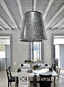 Zinc lampshade in country-house-style dining room