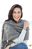 A brunette woman wearing a grey shawl