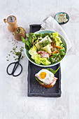 Ham and egg on toast with a colourful salad and truffle butter