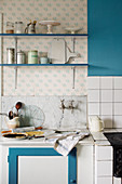 Blueberry pie and kitchen utensils by a vintage kitchen sink