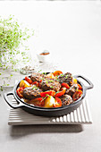 A casserole with pistachio and mince kebabs, tomatoes and potatoes