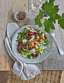 A colourful summer salad with grilled pineapple, chicken breast and feta cheese