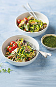 Courgetti with blistered tomatoes, squid, chorizo and salsa verde