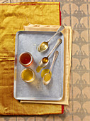 Various types of honey in glass jars and on spoons