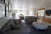 Grey sofas and round wicker table in Hamptons-style living room