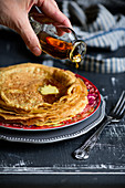 Egg pancakes with a drizzle of maple syrup and dollop of butter