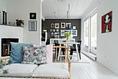 View past rattan sofa into dining area with terrace doors