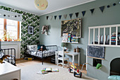 Twin beds, raised platform and grey-blue walls in siblings' bedroom