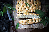 Vegan focaccia with sage and olives (seen from above)