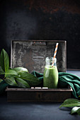 Vegan green smoothie with bananas, peaches, broccoli and spinach