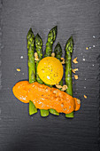 Green asparagus with egg yolk and sauce