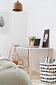 Bright, Scandinavian-style bedroom with desk