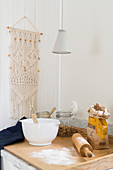 Macrame wall-hanging next to worksurface in kitchen