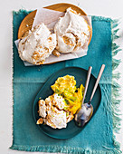 Coconut and cashew meringue clouds with mango