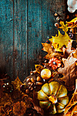 Herbstfrüchte und Laub auf Holzuntergrund