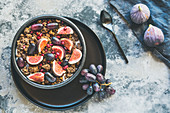 Yoghurt with muesli, figs, grapes and pomegranate seeds