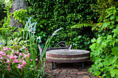 Old millstone as a decorative object in the garden