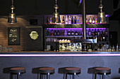 The interior of a bar with dim lighting