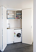 View into utility room seen through open folding doors