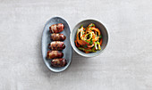 Grilled bacon dates with a pepper salad