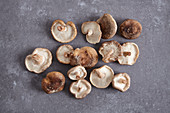 Fresh shiitake mushrooms on a grey surface