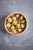 Steamed prawn wontons in a bamboo basket (China)