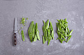 Mange tout being cleaned and diagonally sliced